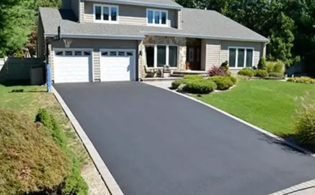 Newly paved asphalt driveway outside a modern house