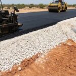 Asphalt pavement base construction in Texas with compacted sub-base and drainage