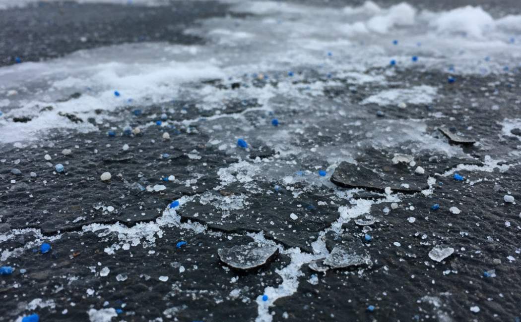 Ice melt chemicals are damaging the asphalt driveway surface